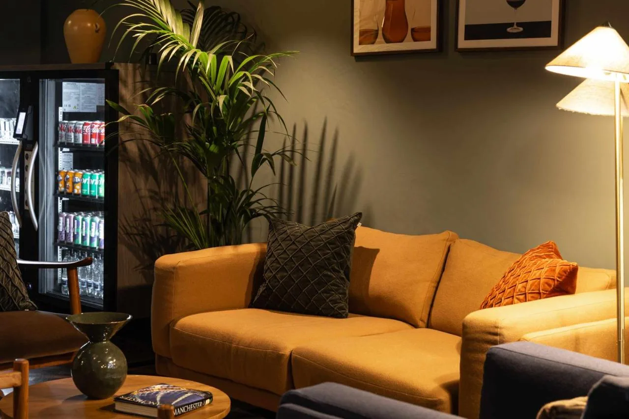 a living room with a couch and a plant at Cove Minshull Street in Manchester