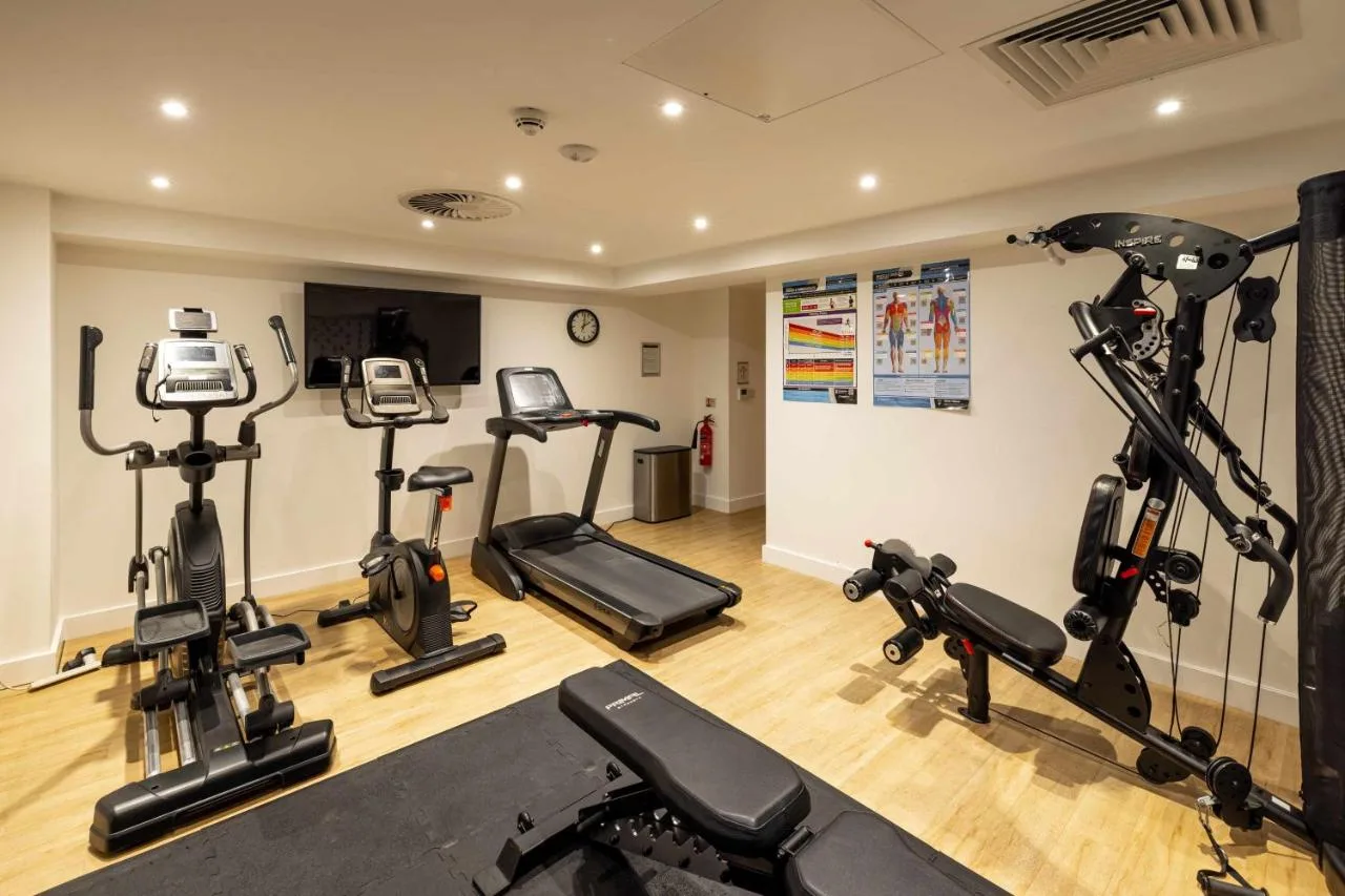a gym with several exercise bikes in a room at Cove Minshull Street in Manchester
